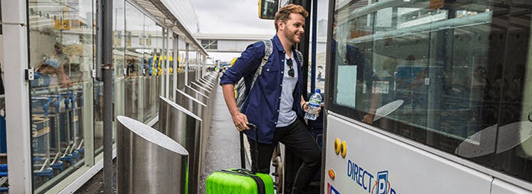 Glasgow airport hotels with park and ride parking - Man with luggage getting on transfer bus