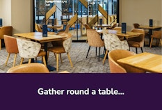 NCL Aspire Lounge gather round a table